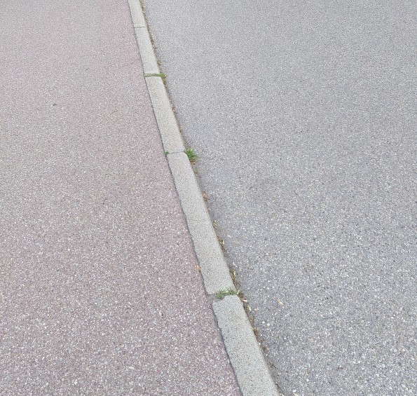 Asphaltierter Gehweg, Bordstein und asphaltierte Fahrbahn